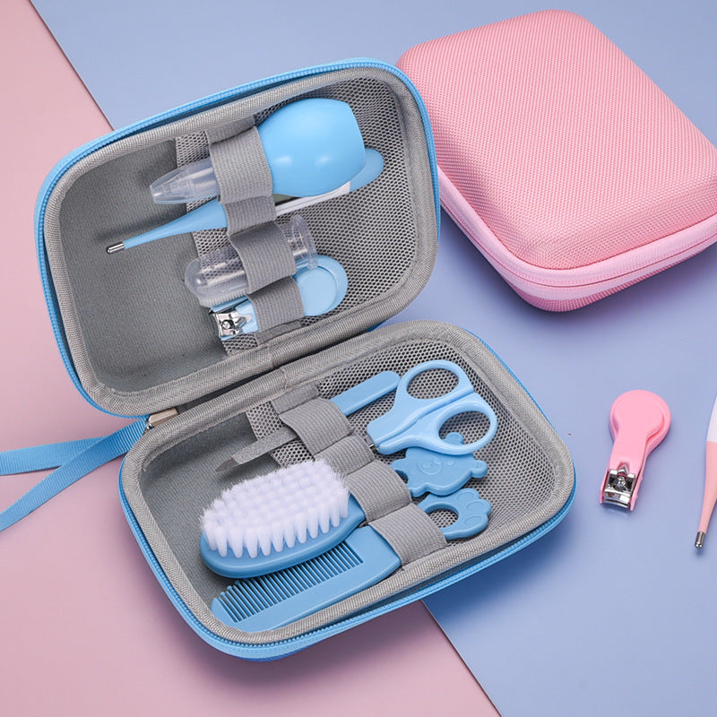 Baby grooming kit with tools in a gray case on a pink and blue background