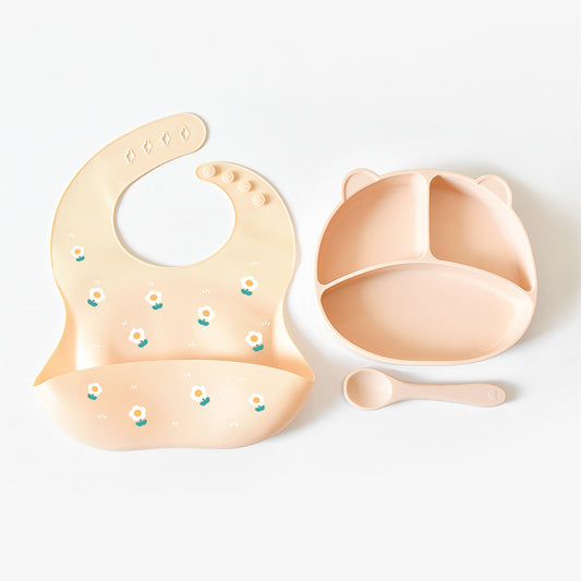 Baby bib and bowl set with floral patterns on a white background