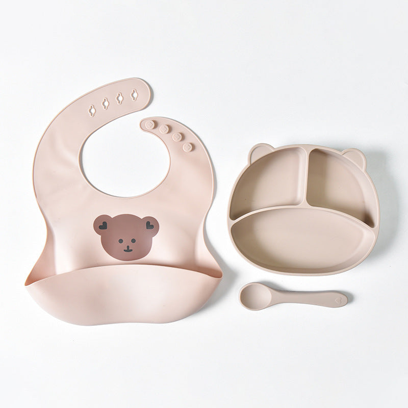 Baby bib, plate, and spoon set with bear design on a white background