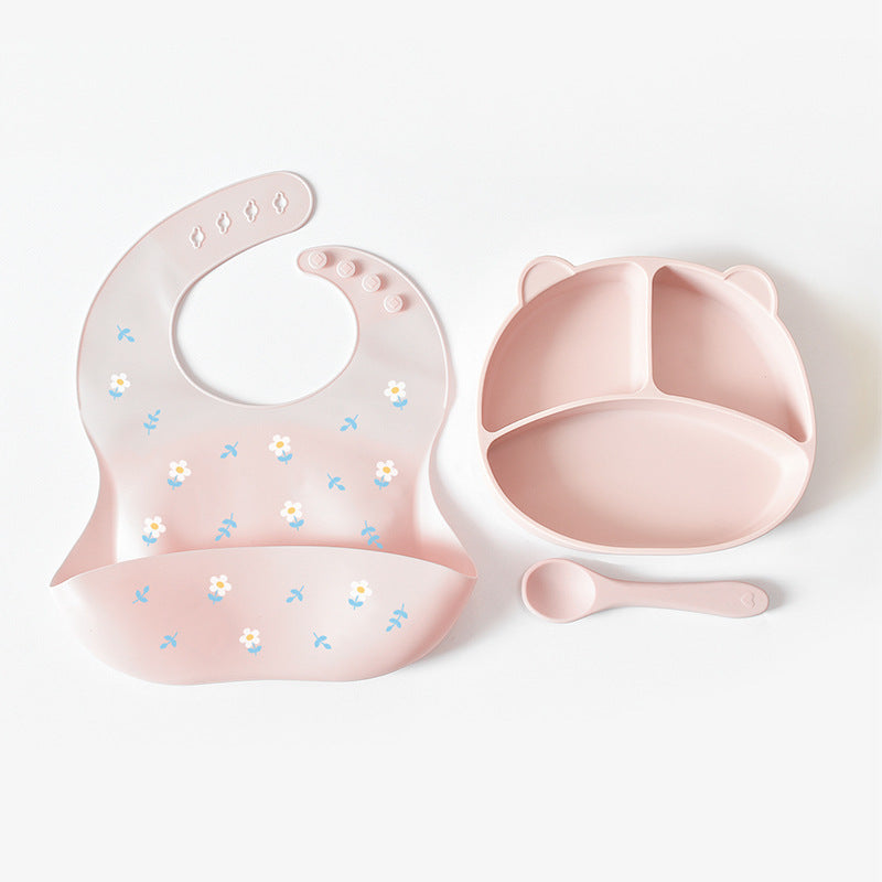Pink baby bib and bowl set on a white background