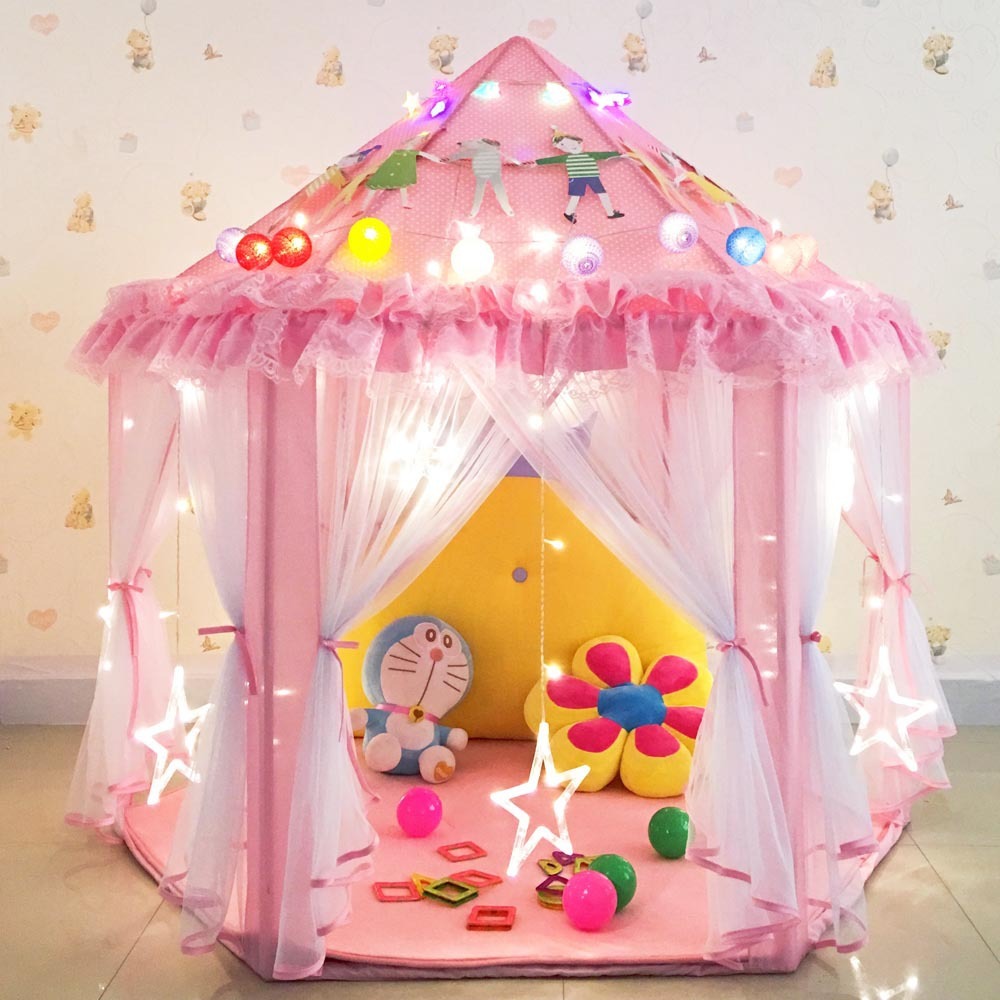 Pink children's play tent with lights and toys inside, on a light-colored floor.
