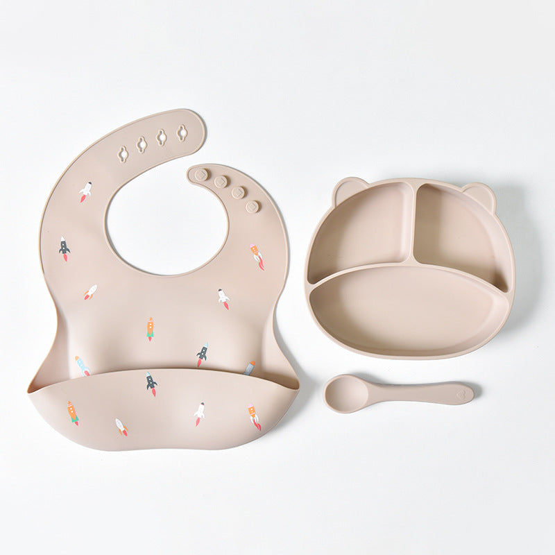 Baby feeding set with bib, bowl, and spoon on a white background